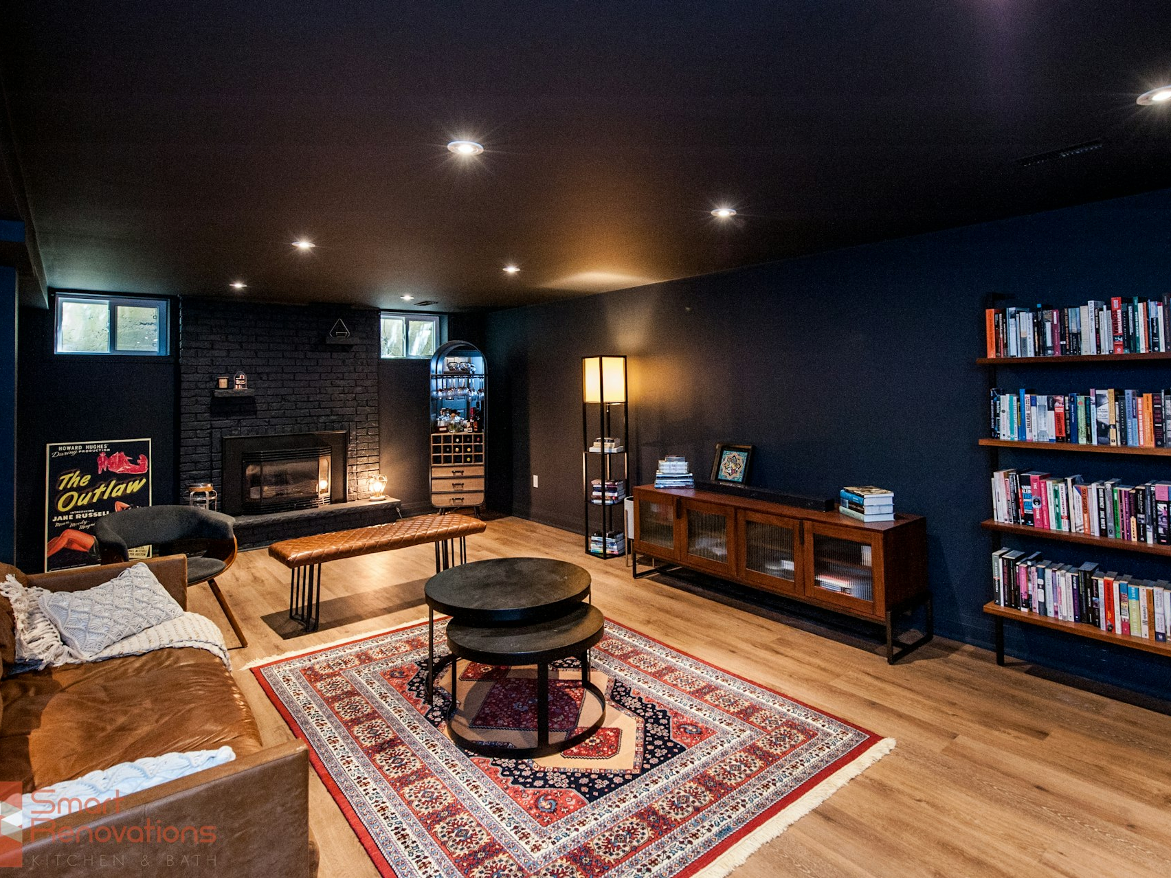 Cozy living room with fireplace and bookshelves.